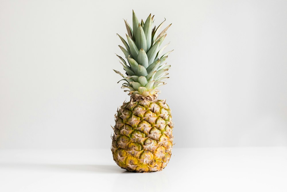A whole pineapple on a light studio background, original photograph
